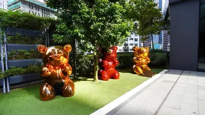four statues of teddy bears sitting on the grass at Star KLCC Elegant 2-3pax by DingDing in Kuala Lumpur