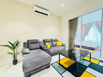 a living room with a couch and a glass table at Quill Residence KL by DeUrban in Kuala Lumpur