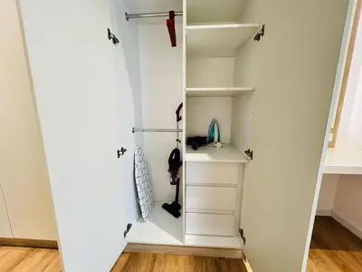 a room with a white closet with shelves at Quill Residence KL by DeUrban in Kuala Lumpur