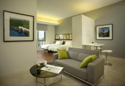 a living room with a couch and a bed at The Signature Hotel & Serviced Suites Hartamas Kuala Lumpur in Kuala Lumpur