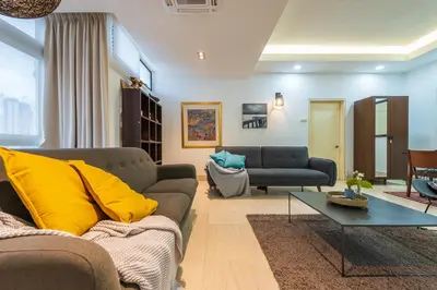 a living room with a couch and a table at Fahrenheit 88 Kuala Lumpur in Kuala Lumpur