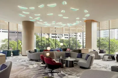 a lobby with couches and tables and windows at Holiday Inn Kuala Lumpur Bangsar by IHG in Kuala Lumpur