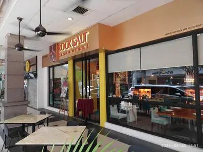 a restaurant with tables and chairs in front of a window at KL Dorsett Damas Grandeur Suite-F-Parking, Self C-In in Kuala Lumpur