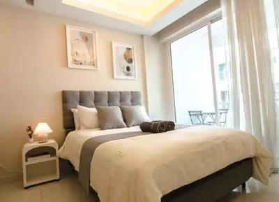 a bedroom with a large bed with a large window at KL Dorsett Damas Grandeur Suite-F-Parking, Self C-In in Kuala Lumpur