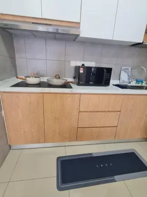 a kitchen with two bowls on the counter and a microwave at KL View 3BedRoom 2carpark MRT Station Cheras Maluri FreeWifi C41 in Kuala Lumpur