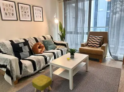 a living room with a couch and a table at Bintang Fairlane Residence, Cozy Fam Suite with Bathtub - 2B2R in Kuala Lumpur