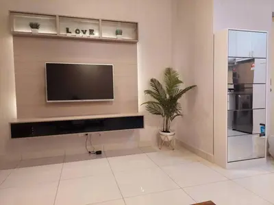 a living room with a flat screen tv on a wall at Arte Mont Kiara in Kuala Lumpur