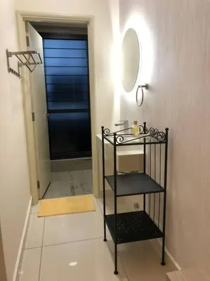 a bathroom with a black shelf and a mirror at Arte Mont Kiara in Kuala Lumpur