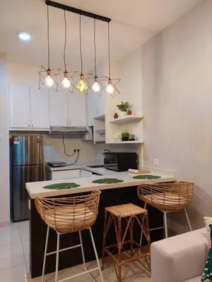 a kitchen with a counter and stools in a room at Arte Mont Kiara in Kuala Lumpur