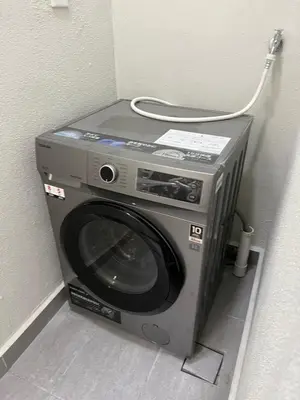 a washing machine sitting in the corner of a room at 2R2B Chan Sow Lin Trion 2 - 6 pax in Kuala Lumpur