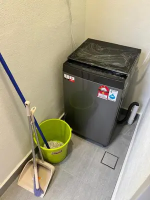 a small refrigerator with a bucket and a broom at 2R2B Chan Sow Lin Trion 2 - 6 pax in Kuala Lumpur
