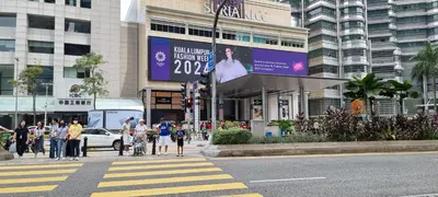 a group of people crossing a street in front of a building at Star Superior KLCC Suite 4-5pax by LavishHome in Kuala Lumpur