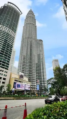 two tall buildings in a city with a street at Star Superior KLCC Suite 4-5pax by LavishHome in Kuala Lumpur