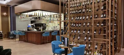 a bar with a wall of wine bottles at Star Superior KLCC Suite 4-5pax by LavishHome in Kuala Lumpur