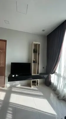 a living room with a couch and a window at City Centre KLCC in Kuala Lumpur