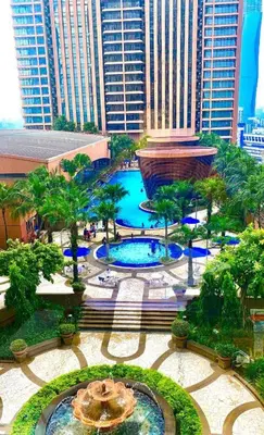 a view of a fountain in a city with tall buildings at Unique Suite Times Square at Bukit Bintang Kuala Lumpur in Kuala Lumpur