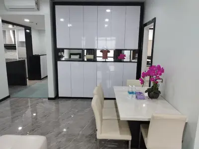 a dining room with a table and some flowers on it at Times Square Super Suites at Bukit Bintang KL in Kuala Lumpur