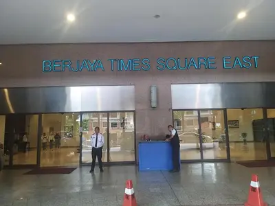 two men are standing in front of a store at Times Square Super Suites at Bukit Bintang KL in Kuala Lumpur