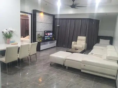 a living room with white couches and a television at Times Square Super Suites at Bukit Bintang KL in Kuala Lumpur