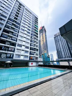 a swimming pool in front of some tall buildings at Fahrenheit 88 Pavillion Bukit Bintang 3 bedroom in Kuala Lumpur