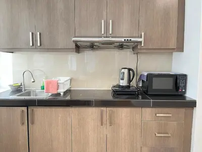 a kitchen with a sink and a microwave at Parkview Service Apartment By Bonjour in Kuala Lumpur