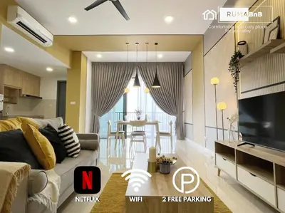 a living room with a couch and a dining room at Lemon Loft 2BR opposite MyTown near TRX by RumaBnB in Kuala Lumpur