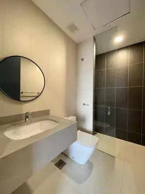 a bathroom with a toilet and a sink and a mirror at Lemon Loft 2BR opposite MyTown near TRX by RumaBnB in Kuala Lumpur
