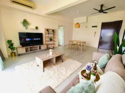 a living room with a couch and a tv at Regalia Residence by Luvit Stay in Kuala Lumpur