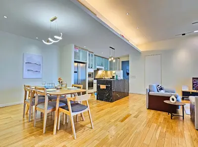 a dining room and living room with a table and chairs at St Mary KLCC Luxury 3BR High End Residence 7min Walk to Pavilion and Bukit Bintang by Cloud Host in Kuala Lumpur