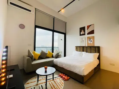 a bedroom with a bed and a couch and a table at EST Bangsar KL Sentral by DeUrban in Kuala Lumpur