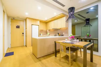 a kitchen with a table and a dining room at 188 Premium Suites by Plush in Kuala Lumpur