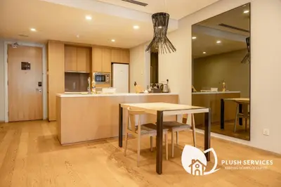 a kitchen with a table and a counter top at 188 Premium Suites by Plush in Kuala Lumpur