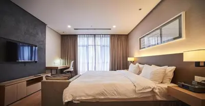 a hotel room with a bed and a television at 188 Premium Suites by Plush in Kuala Lumpur