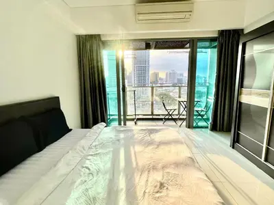 a bedroom with a bed and a view of a city at KL CITY CENTRE nearby KLCC in Kuala Lumpur