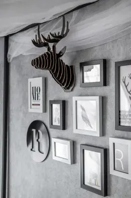 a wall with pictures and a deer head on it at M-Vertica Sunway Velocity Cheras by Luvit Stay in Kuala Lumpur