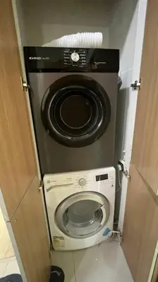 a washer and dryer in a small bathroom at City Centre KLCC in Kuala Lumpur