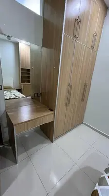 a room with a wooden desk and a closet at City Centre KLCC in Kuala Lumpur