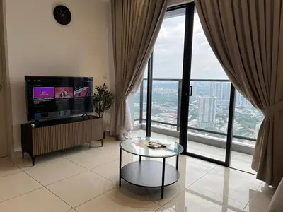 a living room with a glass table and large windows at Trion KL by Dreamcloud Sdn Bhd in Kuala Lumpur
