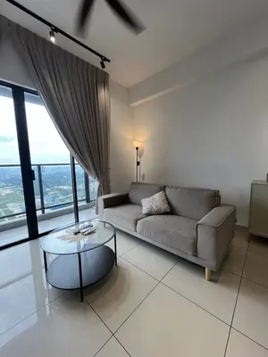 a living room with a couch and a glass table at Trion KL by Dreamcloud Sdn Bhd in Kuala Lumpur