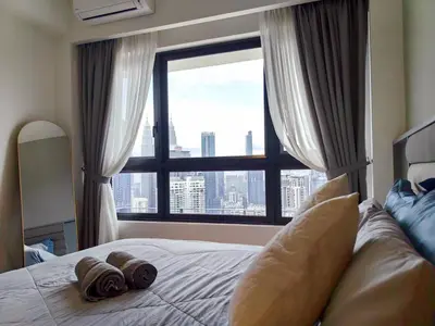 a bedroom with a bed with a large window at TRX Agile Bukit Bintang KLCC View 8pax Family Suites in Kuala Lumpur