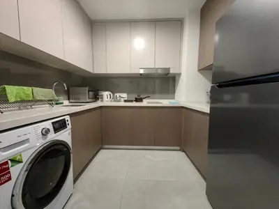 a kitchen with a washing machine in a kitchen at TRX Agile Bukit Bintang KLCC View 8pax Family Suites in Kuala Lumpur