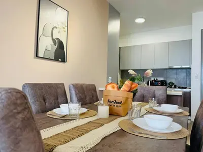 a dining room with a table with plates and bowls at MVC50#Family Suite 9pax 3 Rooms M Vertica Velocity Mall Cheras in Kuala Lumpur