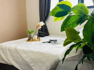 a bed with a white table with plants on it at MVC50#Family Suite 9pax 3 Rooms M Vertica Velocity Mall Cheras in Kuala Lumpur