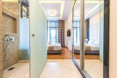 a bathroom with a shower and two beds at Dorsett 1 min to TRX Pavilion 127 in Kuala Lumpur