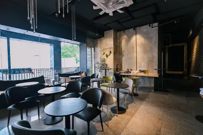 a restaurant with tables and chairs and a large window at Kingston Hotel 4 - Hulo Bukit Bintang in Kuala Lumpur