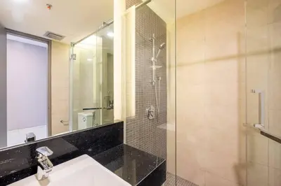 a bathroom with a sink and a shower at Societe Studio Sri Hartamas By Feel Home in Kuala Lumpur