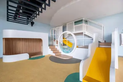 a room with a spiral staircase with a mirror at Societe Studio Sri Hartamas By Feel Home in Kuala Lumpur