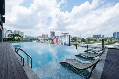 a swimming pool on the roof of a building at Societe Studio Sri Hartamas By Feel Home in Kuala Lumpur
