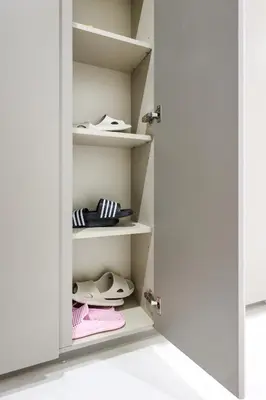 a closet with white shelves and shoes at Eaton Residence KLCC by GB in Kuala Lumpur