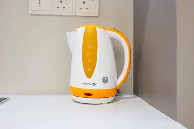 an orange and white blender sitting on a counter at Eaton Residence KLCC by GB in Kuala Lumpur